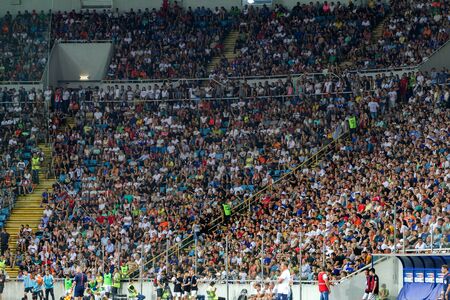 ODESSA UKRAINE - July 28, 2019: spectators at stadium. Crowds of fans in stands of football stadium during match Shakhtar (Donetsk) -Dynamo (Kiev). Grandstand with fans. Stands with football fansのeditorial素材