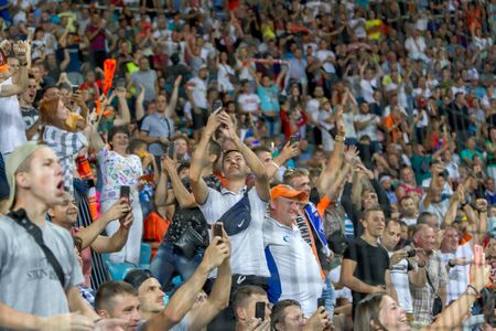 ODESSA UKRAINE - July 28, 2019: spectators at stadium. Crowds of fans in stands of football stadium during match Shakhtar (Donetsk) -Dynamo (Kiev). Grandstand with fans. Stands with football fansのeditorial素材