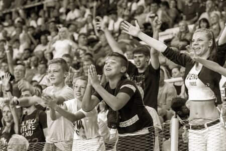 ODESSA UKRAINE - July 28, 2019: spectators at stadium. Crowds of fans in stands of football stadium...