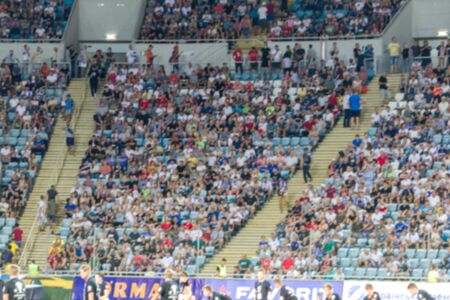 ODESSA UKRAINE - July 28, 2019: Out of focus, not sharp sport background - spectators at stadium....