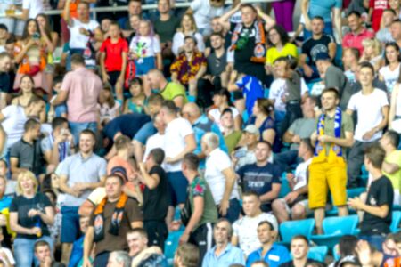 ODESSA UKRAINE - July 28, 2019: Out of focus, not sharp sport background - spectators at stadium....