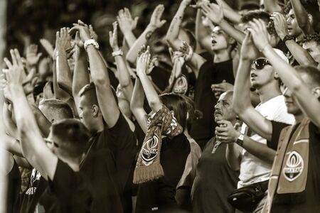 ODESSA UKRAINE - July 28, 2019: spectators at stadium. Crowds of fans in stands of football stadium during match Shakhtar (Donetsk) -Dynamo (Kiev). Grandstand with fans. Stands with football fansのeditorial素材