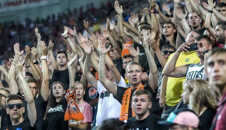 ODESSA UKRAINE - July 28, 2019: spectators at stadium. Crowds of fans in stands of football stadium during match Shakhtar (Donetsk) -Dynamo (Kiev). Grandstand with fans. Stands with football fansのeditorial素材