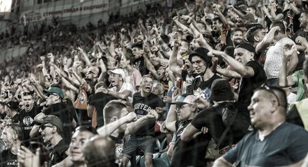 ODESSA UKRAINE - July 28, 2019: spectators at stadium. Crowds of fans in stands of football stadium during match Shakhtar (Donetsk) -Dynamo (Kiev). Grandstand with fans. Stands with football fansのeditorial素材