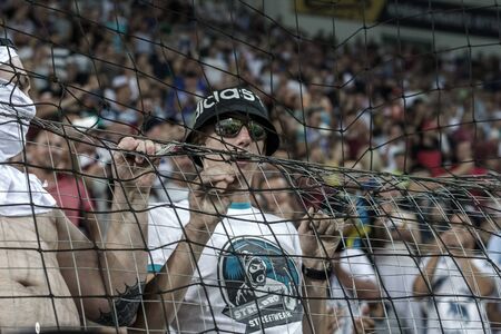ODESSA UKRAINE - July 28, 2019: spectators at the stadium. Crowds of fans in the stands of a football stadium during the match Shakhtar (Donetsk)-Dynamo (Kiev). Grandstand with fans. Stands with football fansのeditorial素材