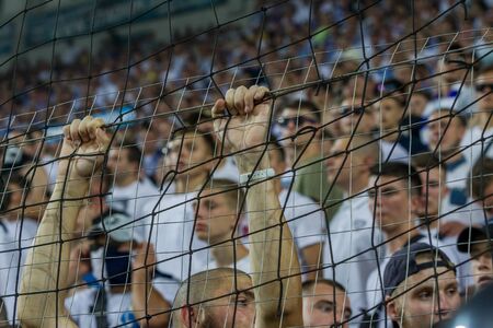 ODESSA UKRAINE - July 28, 2019: spectators at the stadium. Crowds of fans in the stands of a...