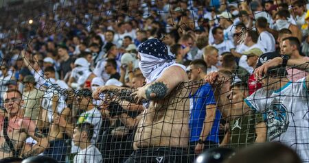 ODESSA UKRAINE - July 28, 2019: spectators at the stadium. Crowds of fans in the stands of a football stadium during the match Shakhtar (Donetsk)-Dynamo (Kiev). Grandstand with fans. Stands with football fansのeditorial素材