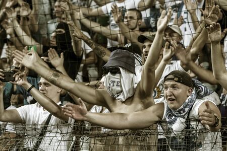 ODESSA UKRAINE - July 28, 2019: spectators at the stadium. Crowds of fans in the stands of a football stadium during the match Shakhtar (Donetsk)-Dynamo (Kiev). Grandstand with fans. Stands with football fansのeditorial素材
