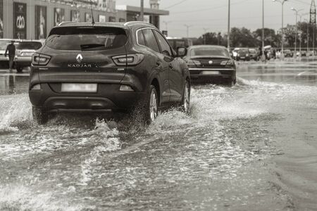 Odessa, Ukraine - August 9, 2019: driving car on flooded road during flood caused by torrential...