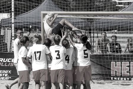 Odessa, Ukraine - July 21, 2019: Beach soccer championship for women on beach. Football in sand. Young beautiful girls play beach soccer, rejoice in victory in tournament on the sand of city beachのeditorial素材