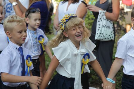 ODESSA UKRAINE - September 1, 2019: First call. 1 September is Day of Knowledge. Solemn school line, first grade, back to school. School holiday Knowledge Day. Little schoolchildren, first gradersのeditorial素材