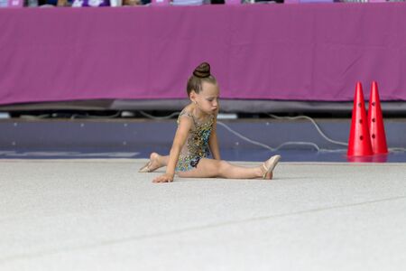 ODESSA, UKRAINE - September 21, 2019: children, girls compete in rhythmic gymnastics at Ukrainian championship in rhythmic gymnastics among children. Young gymnasts competing in arena of the gymのeditorial素材