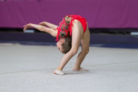 ODESSA, UKRAINE - September 21, 2019: children, girls compete in rhythmic gymnastics at Ukrainian championship in rhythmic gymnastics among children. Young gymnasts competing in arena of the gymのeditorial素材