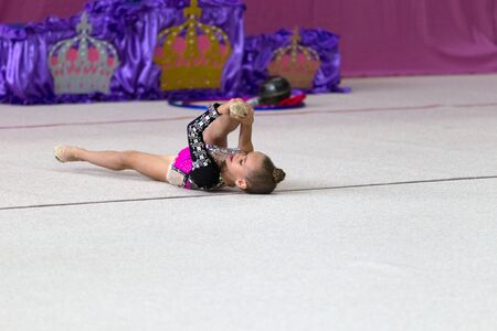 ODESSA, UKRAINE - September 21, 2019: children, girls compete in rhythmic gymnastics at Ukrainian championship in rhythmic gymnastics among children. Young gymnasts competing in arena of the gymのeditorial素材