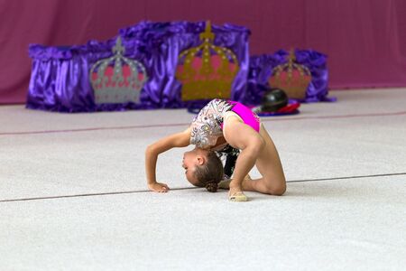 ODESSA, UKRAINE - September 21, 2019: children, girls compete in rhythmic gymnastics at Ukrainian championship in rhythmic gymnastics among children. Young gymnasts competing in arena of the gymのeditorial素材