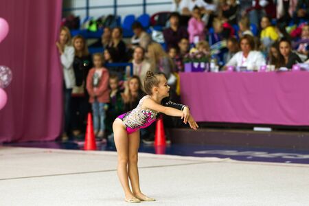 ODESSA, UKRAINE - September 21, 2019: children, girls compete in rhythmic gymnastics at Ukrainian championship in rhythmic gymnastics among children. Young gymnasts competing in arena of the gymのeditorial素材