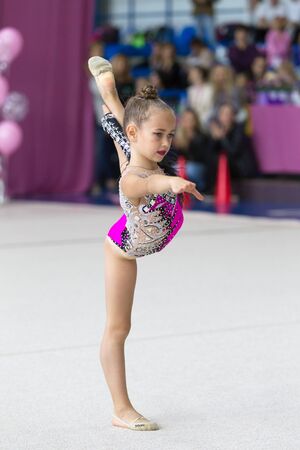 ODESSA, UKRAINE - September 21, 2019: children, girls compete in rhythmic gymnastics at Ukrainian championship in rhythmic gymnastics among children. Young gymnasts competing in arena of the gymのeditorial素材