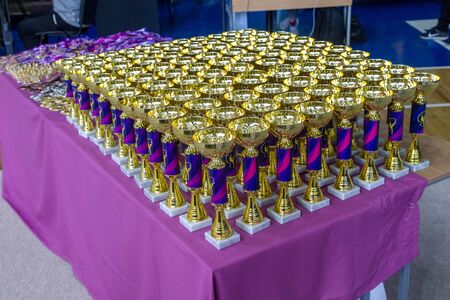 ODESSA, UKRAINE - Around 2019: sports cups and medals, crystal crowns for winners of the rhythmic gymnastics tournament among young children. Sports awards for winners of gymnastics competitionsのeditorial素材