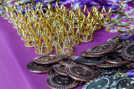 ODESSA, UKRAINE - Around 2019: sports cups and medals, crystal crowns for winners of the rhythmic gymnastics tournament among young children. Sports awards for winners of gymnastics competitionsのeditorial素材