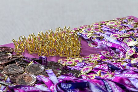 ODESSA, UKRAINE - Around 2019: sports cups and medals, crystal crowns for winners of the rhythmic...