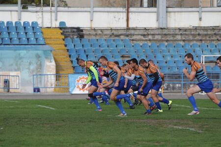 ODESSA, UKRAINE - SEPTEMBER 29, 2019: Odessa rugby team - Polytechnic in Kiev. Intense struggle of rugby players for ball. A dynamic game on the green field of stadium. Fierce Rugby Fightのeditorial素材