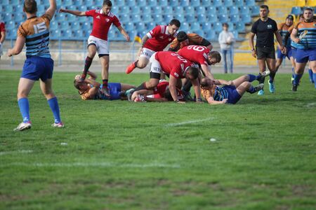 ODESSA, UKRAINE - SEPTEMBER 29, 2019: Odessa rugby team - Polytechnic in Kiev. Intense struggle of rugby players for ball. A dynamic game on the green field of stadium. Fierce Rugby Fightのeditorial素材