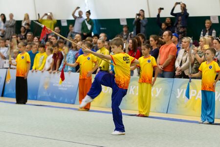 ODESSA, UKRAINE - October 1, 2019: Wushu athlete during the Wushu competition among children. Young athletes in competitions perform Chinese martial arts called Shaolin Kung Fu (Shaolin Wushu)のeditorial素材