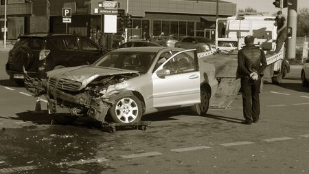 ODESSA, UKRAINE - October 16, 2019: Car accident, head-on collision. A tow truck loads a wrecked car after an accident. Traffic police officer during an investigation in a traffic accident zoneのeditorial素材