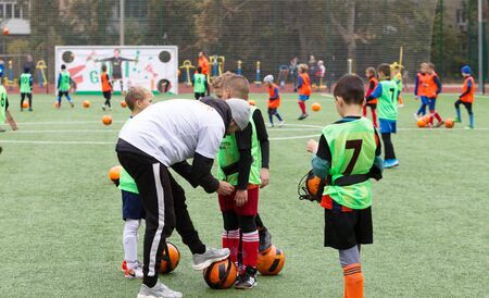 ODESSA, UKRAINE October 26, 2019: FC SHAKHTAR SOCIAL program for development of children's football sports, healthy lifestyles. Younger kick soccer on green futsal field during soccer festivalのeditorial素材
