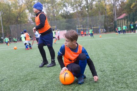 ODESSA, UKRAINE October 26, 2019: FC SHAKHTAR SOCIAL program for development of children's football sports, healthy lifestyles. Younger kick soccer on green futsal field during soccer festivalのeditorial素材