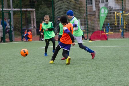 ODESSA, UKRAINE October 26, 2019: FC SHAKHTAR SOCIAL program for development of children's football sports, healthy lifestyles. Younger kick soccer on green futsal field during soccer festivalのeditorial素材