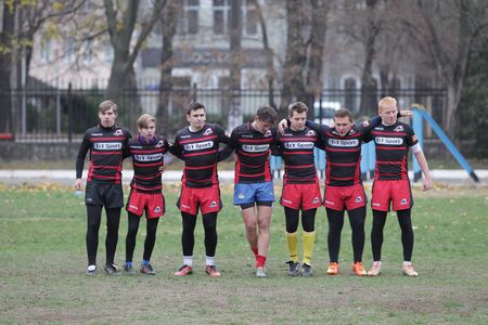 Odessa, Ukraine November 24, 2019: local Rugby clubs engaged in fierce fight on green unequipped field in Rugby Derby tournament. Contact fierce clash in Rugby athletes on statement of stadium. Battleのeditorial素材
