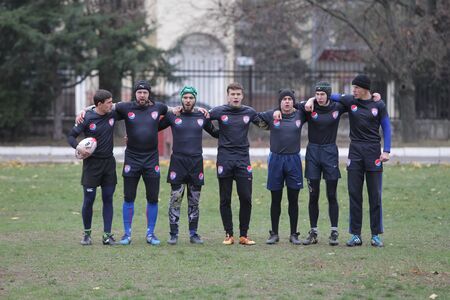 Odessa, Ukraine November 24, 2019: local Rugby clubs engaged in fierce fight on green unequipped field in Rugby Derby tournament. Contact fierce clash in Rugby athletes on statement of stadium. Battleのeditorial素材