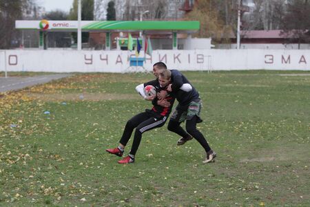Odessa, Ukraine November 24, 2019: local Rugby clubs engaged in fierce fight on green unequipped...