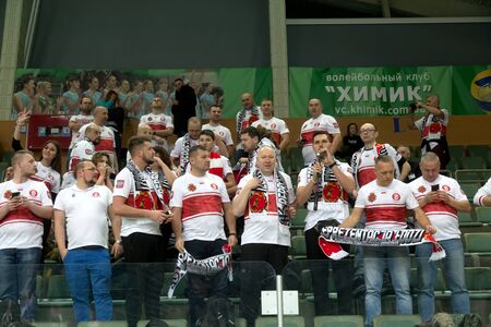 Odessa, Yuzhny, Ukraine-November 27, 2019. Group of fans with flags of Poland in stands during European volleyball championship among women. VK Khimik - LKS Kommersant Poland (black). Group tournamentのeditorial素材