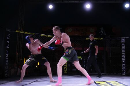 ODESSA, UKRAINE-June 30, 2019: Fighters of MMA boxers are fighting without rules in cage ring of...