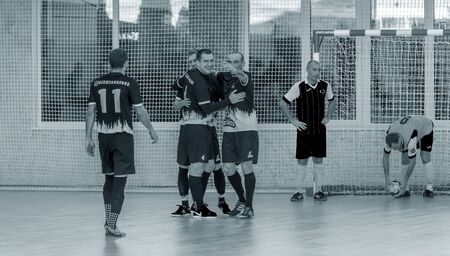 ODESSA, UKRAINE December 15, 2019: Unidentified local team players play futsal futsal tournament on the parquet floor. The right moment of a sports soccer game in an indoor hall, indoor soccerのeditorial素材