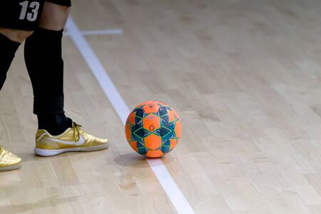 ODESSA, UKRAINE December 15, 2019: Unidentified local team players play futsal futsal tournament on the parquet floor. The right moment of a sports soccer game in an indoor hall, indoor soccerのeditorial素材