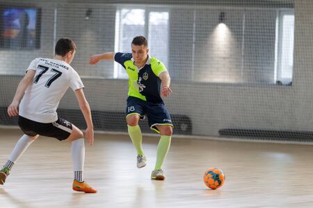 ODESSA, UKRAINE - CIRKA, 202020: Unidentified local team players play futsal futsal tournament on the parquet floor. The right moment of a sports soccer game in an indoor hall, indoor soccerのeditorial素材