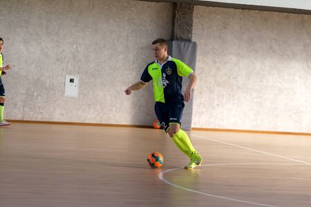 ODESSA, UKRAINE - CIRKA, 202020: Unidentified local team players play futsal futsal tournament on the parquet floor. The right moment of a sports soccer game in an indoor hall, indoor soccerのeditorial素材