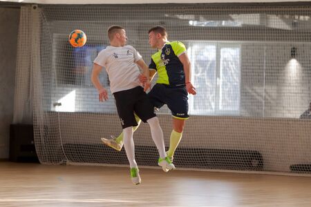 ODESSA, UKRAINE - CIRKA, 202020: Unidentified local team players play futsal futsal tournament on the parquet floor. The right moment of a sports soccer game in an indoor hall, indoor soccerのeditorial素材