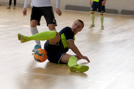ODESSA, UKRAINE - CIRKA, 202020: Unidentified local team players play futsal futsal tournament on the parquet floor. The right moment of a sports soccer game in an indoor hall, indoor soccerのeditorial素材