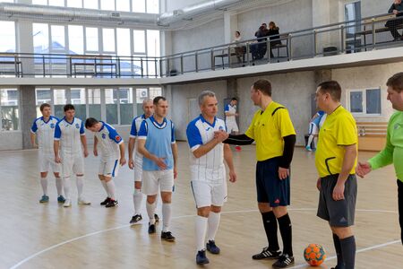 ODESSA, UKRAINE - CIRKA, 202020: Unidentified local team players play futsal futsal tournament on the parquet floor. The right moment of a sports soccer game in an indoor hall, indoor soccerのeditorial素材