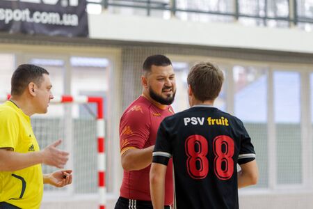 ODESSA, UKRAINE - CIRKA, 202020: Unidentified local team players play futsal futsal tournament on the parquet floor. The right moment of a sports soccer game in an indoor hall, indoor soccerのeditorial素材