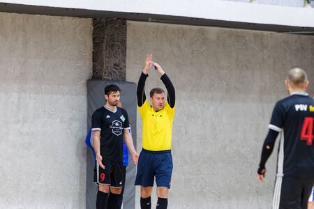 ODESSA, UKRAINE - CIRKA, 202020: Unidentified local team players play futsal futsal tournament on the parquet floor. The right moment of a sports soccer game in an indoor hall, indoor soccerのeditorial素材