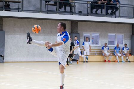 ODESSA, UKRAINE - CIRKA, 202020: Unidentified local team players play futsal futsal tournament on the parquet floor. The right moment of a sports soccer game in an indoor hall, indoor soccerのeditorial素材