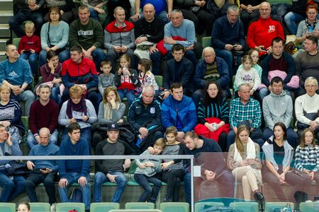 ODESSA, UKRAINA - CIRKA, 2020: Spectators in stands of gym during game of their favorite teams. Sports fans and spectators in stadium racks emotionally support their teamのeditorial素材