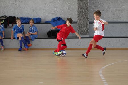 Odessa, Ukraine-December 12, 2019: Little boys, children play mini football in sports hall at sports city Junior championship. Children's sport is healthy lifestyle. Sports children football playersのeditorial素材