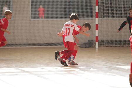Odessa, Ukraine-December 12, 2019: Little boys, children play mini football in sports hall at sports city Junior championship. Children's sport is healthy lifestyle. Sports children football playersのeditorial素材