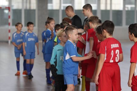 Odessa, Ukraine-December 12, 2019: Little boys, children play mini football in sports hall at sports city Junior championship. Children's sport is healthy lifestyle. Sports children football playersのeditorial素材